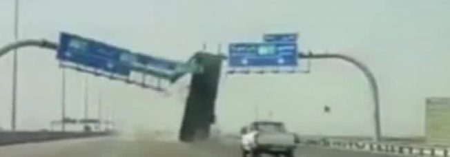 Whoops! Dump truck takes out sign